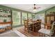Bright, airy dining room with a large table and multiple windows overlooking lush greenery at 3022 8Th Street Ne Ct, Hickory, NC 28601