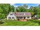Beautiful home with a well-maintained lawn, mature trees, and a classic brick chimney, exuding curb appeal at 3022 8Th Street Ne Ct, Hickory, NC 28601