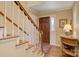 Inviting foyer with a wooden staircase, hardwood floors, and a decorative table, creating a warm welcome at 3022 8Th Street Ne Ct, Hickory, NC 28601
