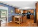 Spacious kitchen features wood floors, cabinetry, granite counters, and an island for food prep at 3022 8Th Street Ne Ct, Hickory, NC 28601