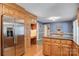 Open kitchen features wood cabinetry, granite countertops, stainless steel fridge, and a dining area at 3022 8Th Street Ne Ct, Hickory, NC 28601