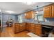 Well-equipped kitchen with wooden cabinets, granite countertops, and a dining area, perfect for culinary adventures at 3022 8Th Street Ne Ct, Hickory, NC 28601
