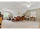 Spacious living room with a plush sofa, patterned armchair, and natural light from multiple windows under vaulted ceiling at 3022 8Th Street Ne Ct, Hickory, NC 28601