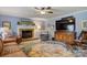 Inviting living room with a brick fireplace and large rug, perfect for entertaining guests or relaxing with Gathering at 3022 8Th Street Ne Ct, Hickory, NC 28601