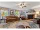 Comfortable living room featuring a cozy fireplace, window views, and ample seating for relaxation and conversation at 3022 8Th Street Ne Ct, Hickory, NC 28601