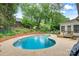 Lush backyard with a fenced pool, a beautiful garden and outdoor seating, perfect for relaxing and entertaining at 3022 8Th Street Ne Ct, Hickory, NC 28601
