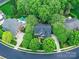 An aerial view of a home with a dark roof, surrounded by trees and a circular driveway at 3203 Blackburn Dr, Waxhaw, NC 28173
