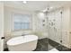 Elegant bathroom features a soaking tub, glass enclosed shower, and stylish tile work at 3203 Blackburn Dr, Waxhaw, NC 28173