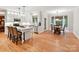 Open kitchen with white cabinets, island seating, and a cozy breakfast nook at 3203 Blackburn Dr, Waxhaw, NC 28173