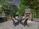 Outdoor fireplace with stone surround, patio furniture, and grill for backyard entertainment at 3203 Blackburn Dr, Waxhaw, NC 28173