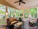 Relaxing screened porch with comfortable seating, glass table, ceiling fan, and views of backyard at 3203 Blackburn Dr, Waxhaw, NC 28173