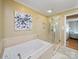 Bright bathroom features a soaking tub and glass-enclosed shower, creating a luxurious and relaxing atmosphere at 3313 Lancaster Hwy, Monroe, NC 28112