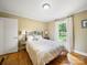 Bedroom features wood floors, a window with backyard view, and neutral décor at 3313 Lancaster Hwy, Monroe, NC 28112