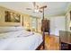 This bedroom boasts wood floors, a four-poster bed, and a ceiling fan at 3313 Lancaster Hwy, Monroe, NC 28112