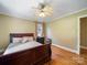 Bedroom features wood floors, ceiling fan, neutral walls, and natural light from the window at 3313 Lancaster Hwy, Monroe, NC 28112