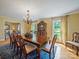Formal dining room featuring a large wooden table, chandelier, and ample natural light at 3313 Lancaster Hwy, Monroe, NC 28112
