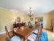 Formal dining room with a long table, chandelier, and hardwood floors at 3313 Lancaster Hwy, Monroe, NC 28112