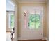Bright foyer with a charming white front door and view of the front lawn at 3313 Lancaster Hwy, Monroe, NC 28112