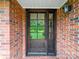 Traditional red brick home featuring a striking stained wood front door with glass panel at 3313 Lancaster Hwy, Monroe, NC 28112