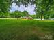 A beautiful brick home surrounded by a large green lawn and mature trees at 3313 Lancaster Hwy, Monroe, NC 28112