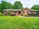 Charming brick home with a well-maintained lawn and manicured landscaping at 3313 Lancaster Hwy, Monroe, NC 28112