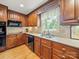 The kitchen features wood cabinetry, granite countertops, tile backsplash, and stainless steel appliances at 3313 Lancaster Hwy, Monroe, NC 28112