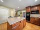 A kitchen island features a granite countertop and wood cabinetry, providing extra space at 3313 Lancaster Hwy, Monroe, NC 28112