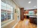 This kitchen space gives way to a sun room with brick details and wood flooring at 3313 Lancaster Hwy, Monroe, NC 28112
