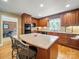 A spacious kitchen is equipped with a large island, wood cabinets, and hardwood floors at 3313 Lancaster Hwy, Monroe, NC 28112
