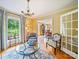 Bright living room with hardwood floors, a crystal chandelier, and large windows at 3313 Lancaster Hwy, Monroe, NC 28112