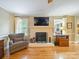 Comfortable living room with a brick fireplace, hardwood floors, and ample natural light at 3313 Lancaster Hwy, Monroe, NC 28112