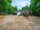 Large outbuilding with gravel parking ideal for equipment storage or a workshop at 3313 Lancaster Hwy, Monroe, NC 28112
