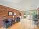 Sunroom with exposed brick wall, hardwood floors, with multiple windows and doors for abundant natural light at 3313 Lancaster Hwy, Monroe, NC 28112