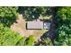 An aerial view shows the house is nestled among mature trees on a spacious lot at 3317 Treyburn Dr, Midland, NC 28107