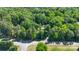 Aerial view of the property surrounded by mature trees and a street nearby at 3317 Treyburn Dr, Midland, NC 28107