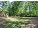 Large backyard area with luscious grass and a view of the back deck of the home at 3317 Treyburn Dr, Midland, NC 28107