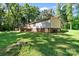 A large backyard area featuring the back side of the home and plenty of grassy space at 3317 Treyburn Dr, Midland, NC 28107