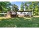 Backyard of property features back deck, a carport, and the rear side of the home at 3317 Treyburn Dr, Midland, NC 28107