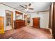 Spacious bedroom with wood furniture, ceiling fan, carpet, and windows providing views at 3317 Treyburn Dr, Midland, NC 28107