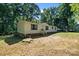 Single-story home with vinyl siding, wood stairs, and lush greenery providing a serene setting at 3317 Treyburn Dr, Midland, NC 28107