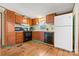 Functional kitchen featuring wood cabinetry, black appliances, and hardwood floors at 3317 Treyburn Dr, Midland, NC 28107