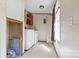 Utility room features a washing machine, dryer, overhead cabinet storage, and an exterior window at 3317 Treyburn Dr, Midland, NC 28107