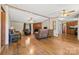 Cozy living room with hardwood floors, ceiling fans, and a fireplace creating a warm ambiance at 3317 Treyburn Dr, Midland, NC 28107