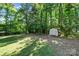 Backyard shed located on the property with green space and mature trees at 3317 Treyburn Dr, Midland, NC 28107
