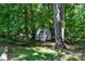Outdoor storage shed on the property surrounded by greenery and mature trees at 3317 Treyburn Dr, Midland, NC 28107