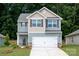 Charming two-story home with blue siding, white garage door, and a well-manicured front lawn at 3339 Burberry Dr, Gastonia, NC 28052