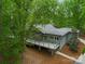 Aerial view of the home highlighting the expansive deck, wooded surroundings, and modern architectural design at 3385 Rainbow Dr # 7A, Marvin, NC 28173