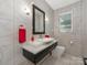 Modern bathroom featuring marble tile, stylish lighting, and a white sink with black vanity at 3385 Rainbow Dr # 7A, Marvin, NC 28173