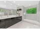 Bathroom with a dual sink vanity, a soaking tub, marble tiling, and serene nature views at 3385 Rainbow Dr # 7A, Marvin, NC 28173