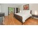 Bright bedroom featuring hardwood floors, a comfortable bed, and views of the lush outdoors at 3385 Rainbow Dr # 7A, Marvin, NC 28173